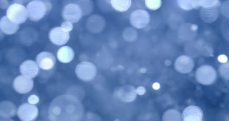 glittering blue lights in blurry bokeh background