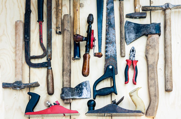 Set of vintage hand construction tools hammers on a wooden background, retro concept .