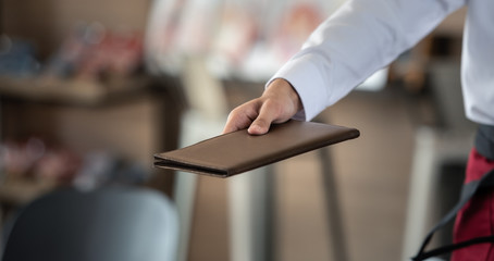 service waitress holding the bill to customer