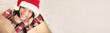 © Maridav - Christmas shopping bags filled with gifts for winter holidays banner panorama with white copy space background. Happy Santa hat Asian woman looking up smiling buying and giving presents panoramic.