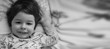 © alexkich - Black and white photo portrait of a young child lying on a pillow