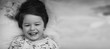 © alexkich - Black and white photo portrait of a young child lying on a pillow