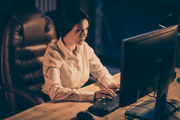 Portrait of her she nice attractive lovely charming focused concentrated busy lady creative designer copywriter typing creating presentation report at night dark place work station