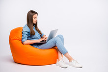 Full Size Profile Side Photo Of Serious Concentrated Girl Work On Her Computer Chat With Start-up Clients Sit Big Bag Lounge Chair Wear Casual Style Clothing Isolated Over White Color Background