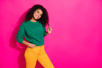 Sticker - Portrait of lovely positive cheerful dark skin girl touch her skin have fun on winter holidays wear green knitted pullover yellow style pants isolated over bright color background