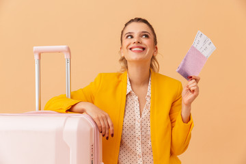 Wall Mural - Photo of smiling cute woman holding passport and tickets