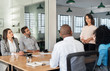 © mavoimages - Young businesswoman talking with her team in an office