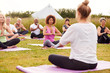 © Monkey Business - Female Teacher Leading Group Of Mature Men And Women In Class At Outdoor Yoga Retreat