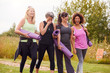 © Monkey Business - Group Of Mature Female Friends On Outdoor Yoga Retreat Walking Along Path Through Campsite