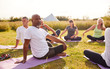 © Monkey Business - Female Teacher Leading Group Of Mature Men And Women In Class At Outdoor Yoga Retreat