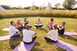 © Monkey Business - Group Of Mature Men And Women In Class At Outdoor Yoga Retreat Sitting Circle Meditating
