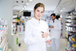 © JackF - female pharmacist is inventorying medicines