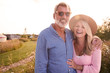 © Monkey Business - Portrait Of Loving Mature Couple In Countryside Hugging Against Flaring Sun