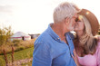 © Monkey Business - Loving Mature Couple In Countryside Kissing Against Flaring Sun