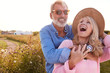 © Monkey Business - Loving Mature Couple In Countryside Hugging Against Flaring Sun