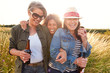 © Monkey Business - Group Of Mature Female Friends Walking Through Field On Camping Vacation Drinking Beer