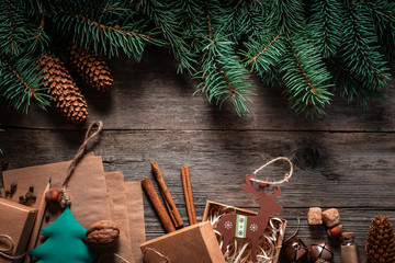 Wall Mural - Christmas green frame from fir branches on a vintage gray board background. Frame of fir branches. Christmas card blank.