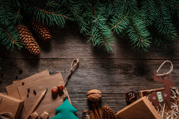 Wall Mural - Christmas green frame from fir branches on a vintage gray board background. Frame of fir branches. Christmas card blank.
