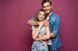 © opolja - Happy loving couple isolated isolated on pink background.