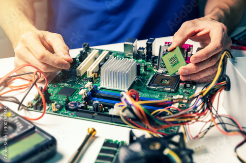Fotomural installing computer hardware - technician install CPU on motherboard