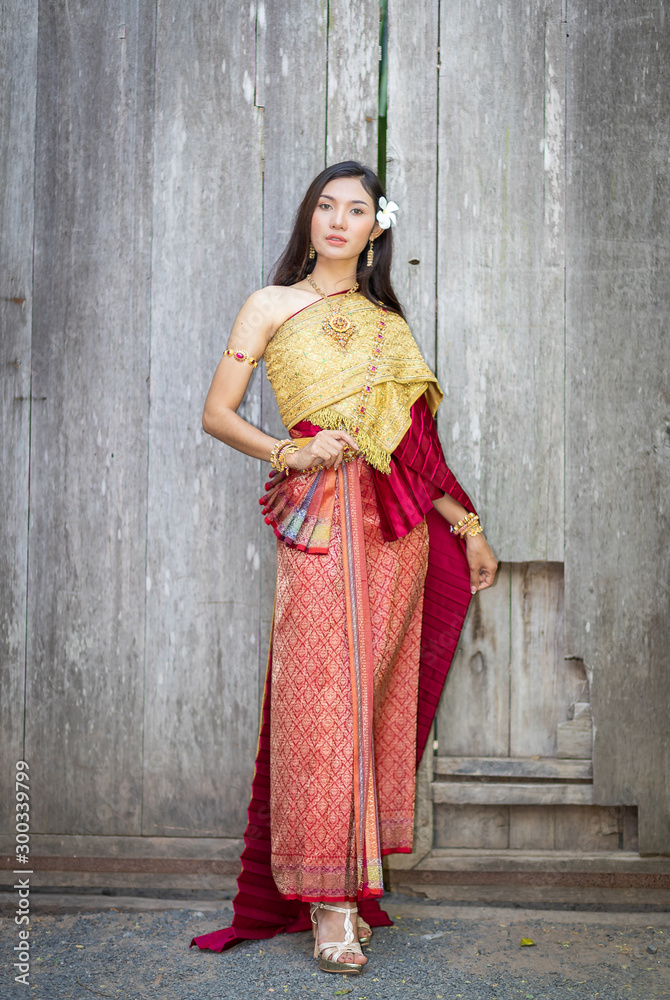 Beautiful woman, Thai national costume, traditional Thai dress, Thai woman,  good mood, beautiful smile background - Image with noise and grain Stock  Photo | Adobe Stock