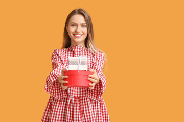 Poster - Beautiful woman with gift boxes on color background