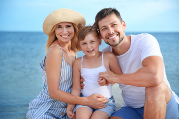 Poster - Portrait of happy family on sea beach