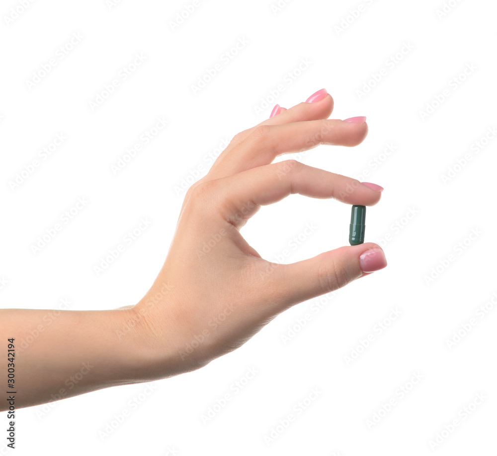Female hand with pill on white background