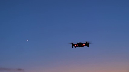 Poster - Drone flying to shoot photo and video at the twilight sunset dark and grain processed
