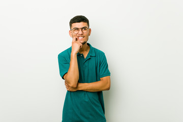 Wall Mural - Young hispanic man biting fingernails, nervous and very anxious.