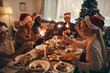 © Seventyfour - Multi-ethnic group of people holding sparklers while enjoying Christmas dinner at home
