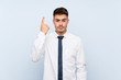 © luismolinero - Handsome businessman over isolated blue background pointing with the index finger a great idea