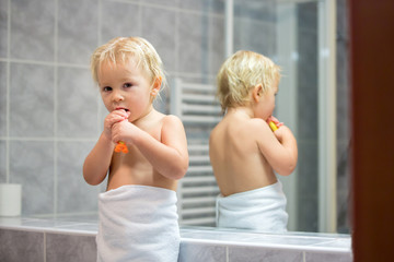 Sticker - Sweet toddler boy, brushing his teeth in bathroom in the evening after bath