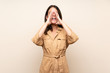© luismolinero - Young girl over isolated background shouting and announcing something