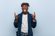 © Asier - Young african black man wearing pajama showing rock gesture with fingers