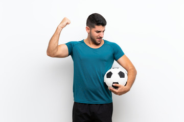 Handsome young football player man over isolated white wall celebrating a victory