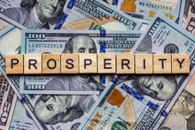 The Word Prosperity On Dollar Usa Background. Welfare, Sufficiency And Wealth Concept