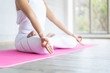 © DG PhotoStock - Woman doing yoga exercise in the indoor gym close up with copy space background.  Concept of good health and wellness.