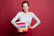 © halfbottle - Young Asian woman studying  with may books.