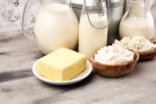 Different  Healthy Dairy Products On Rustic Background With Milk, Cheese, Butter And Cottage