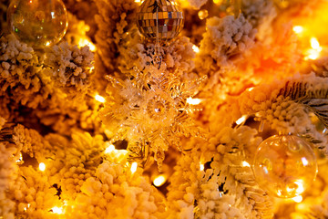 Christmas gold night tree decorated snow illumination and gifts toys, background light bokeh