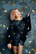 © GVS - Pretty happy woman throwing confetti and dancing enjoying party