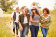 © Monkey Business - Group Of Mature Friends Walking Along Path Through Yurt Campsite