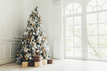 classic christmas new year decorated interior room new year tree. christmas tree with gold decoratio