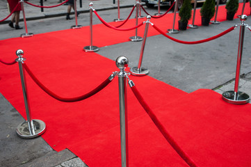 Event party. red carpet entrance with golden stanchions and ropes.