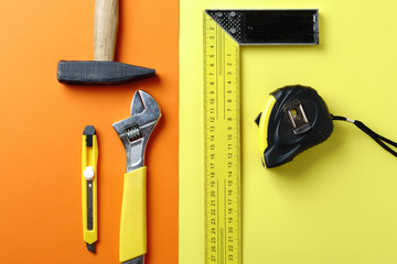 Different tools, hammer, tape measure, key, on a colorful background