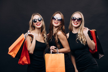 girls posing with purchases after successful friday shopping
