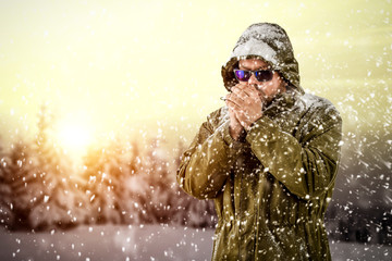 Poster - New Year Christmas snowy winter concept Hipster in green coat and hood.Big man with long beard. Xmas party celebration. New year guy on orange sky with snow and sunshine.Winter holiday and vacation.