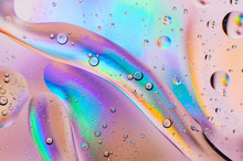 Iridescent Macro Background Of Oil Drops On The Water
