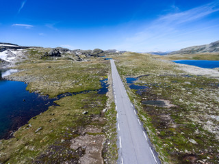 Sticker - The Aurlandsvegen Snow Road is in Aurland, Norway. Scenic road through the mountains with picturesque view